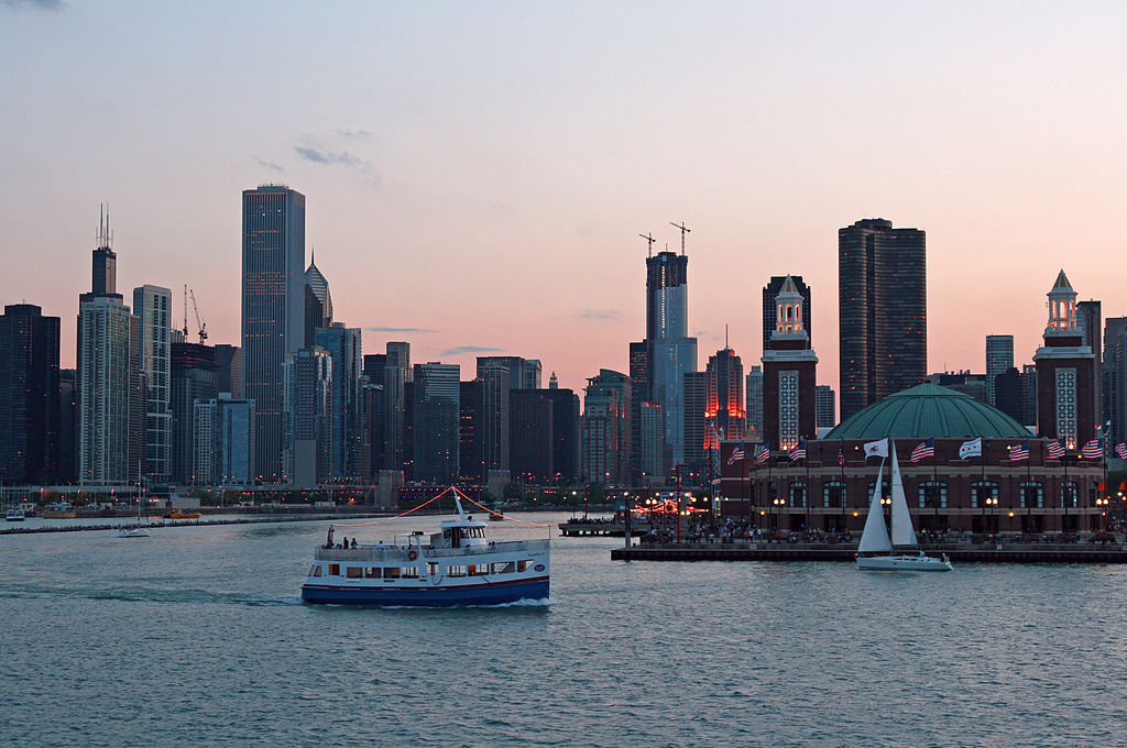 Chicago skyline at night with ferry boat passing by